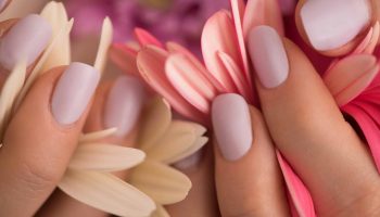 beauty delicate woman hands with manicure holding flower close up